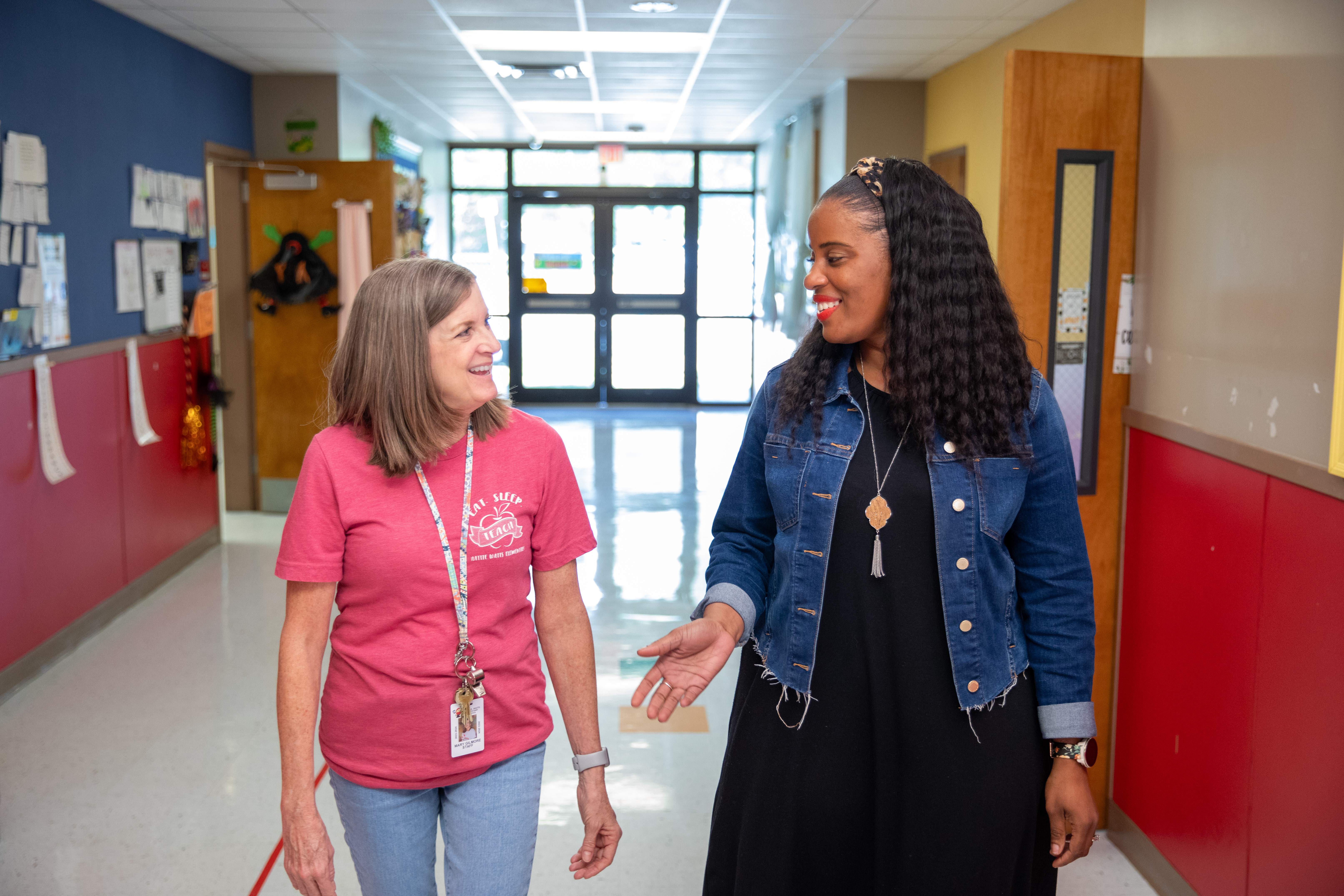 M.Ed. Leadership alumna Rekeisha Trigg walks with a colleague through her St. Mary Parish elementary school.