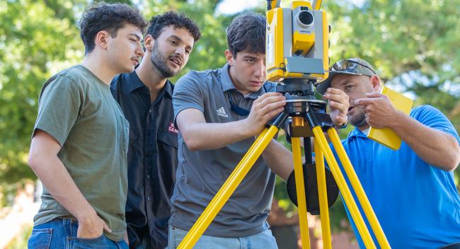 Student engineers work with equipment 